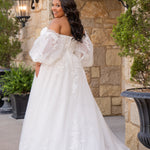 Michelle Bridal MB2618 shown in Ivory. 

Strapless sweetheart ballgown. Soft bridal tulle, floral lace appliques, lightweight satin lining. Natural waistline, A-Line skirt. Bicep optional puff sleeves. Straight across back, center back zipper, train and covered buttons. 