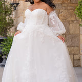 Michelle Bridal MB2618 shown in Ivory. 

Strapless sweetheart ballgown. Soft bridal tulle, floral lace appliques, lightweight satin lining. Natural waistline, A-Line skirt. Bicep optional puff sleeves. Straight across back, center back zipper, train and covered buttons. 