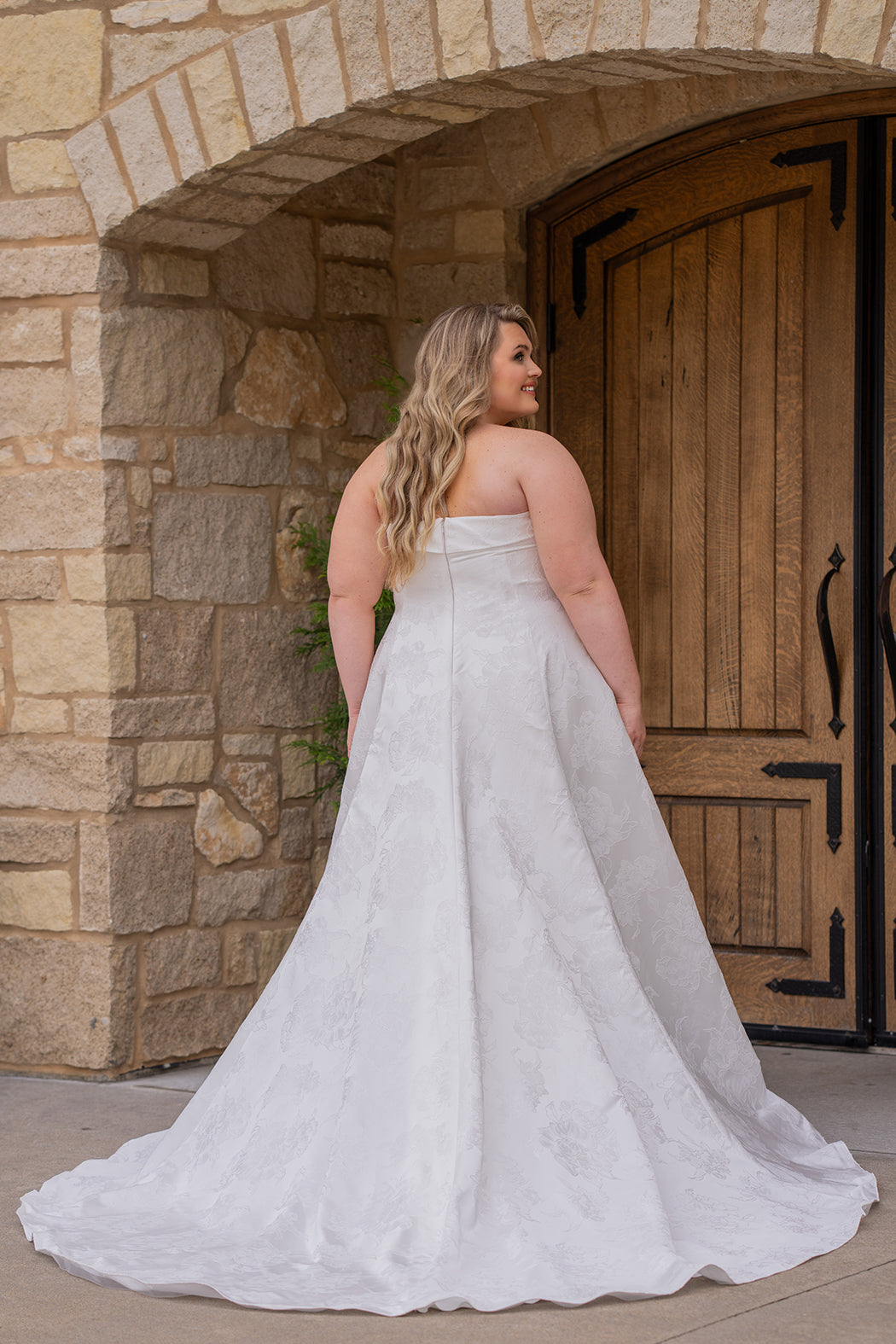 Michelle Bridal MB2619 shown in Ivory. 

Strapless straight across neckline with 3 inch bodice fold over cuff. Soft brocade gown with princess seams and no defined waistline. A-line skirt, horsehair hem, long train and center back zipper. 