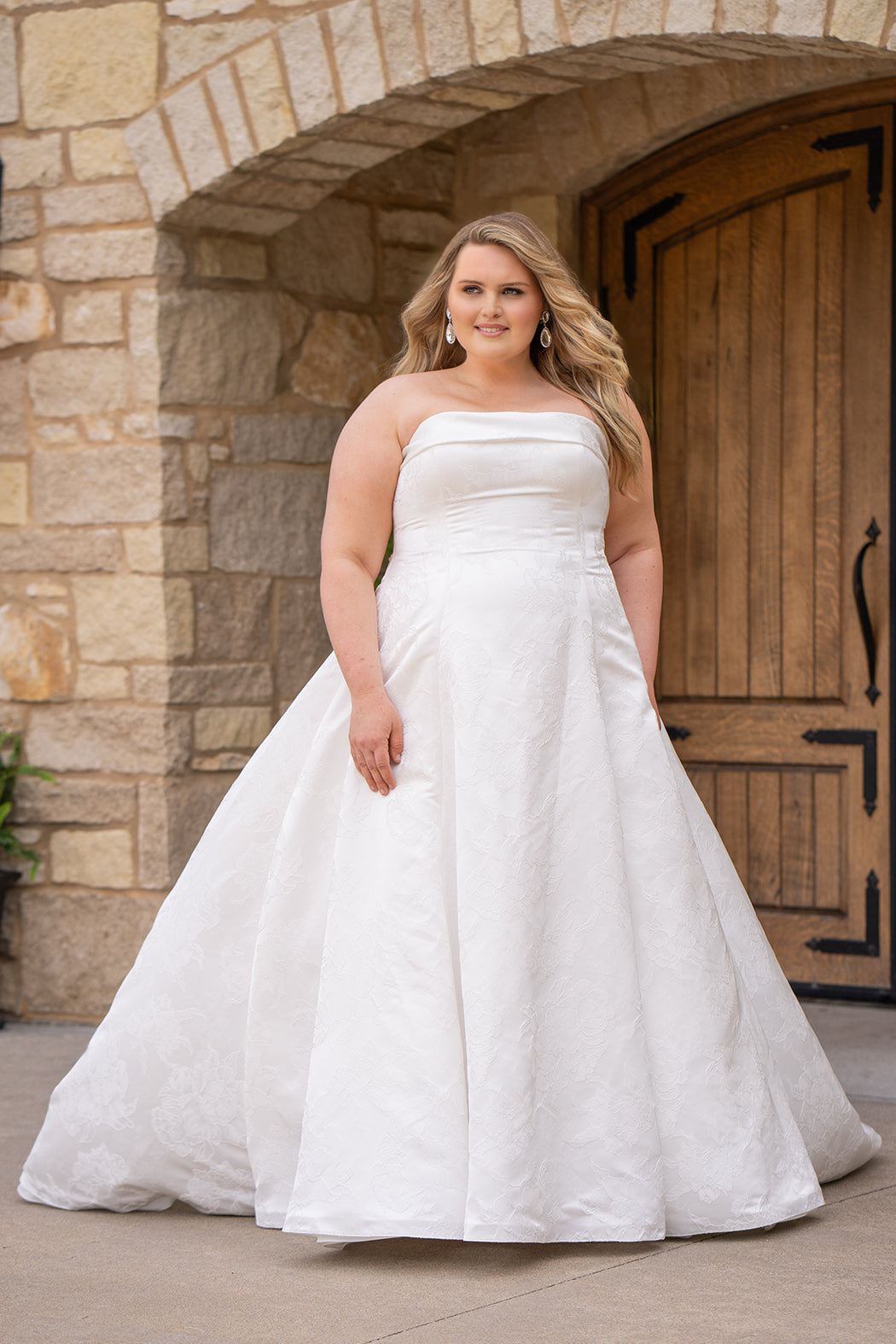 Michelle Bridal MB2619 shown in Ivory. 

Strapless straight across neckline with 3 inch bodice fold over cuff. Soft brocade gown with princess seams and no defined waistline. A-line skirt, horsehair hem, long train and center back zipper. 