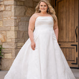 Michelle Bridal MB2619 shown in Ivory. 

Strapless straight across neckline with 3 inch bodice fold over cuff. Soft brocade gown with princess seams and no defined waistline. A-line skirt, horsehair hem, long train and center back zipper. 