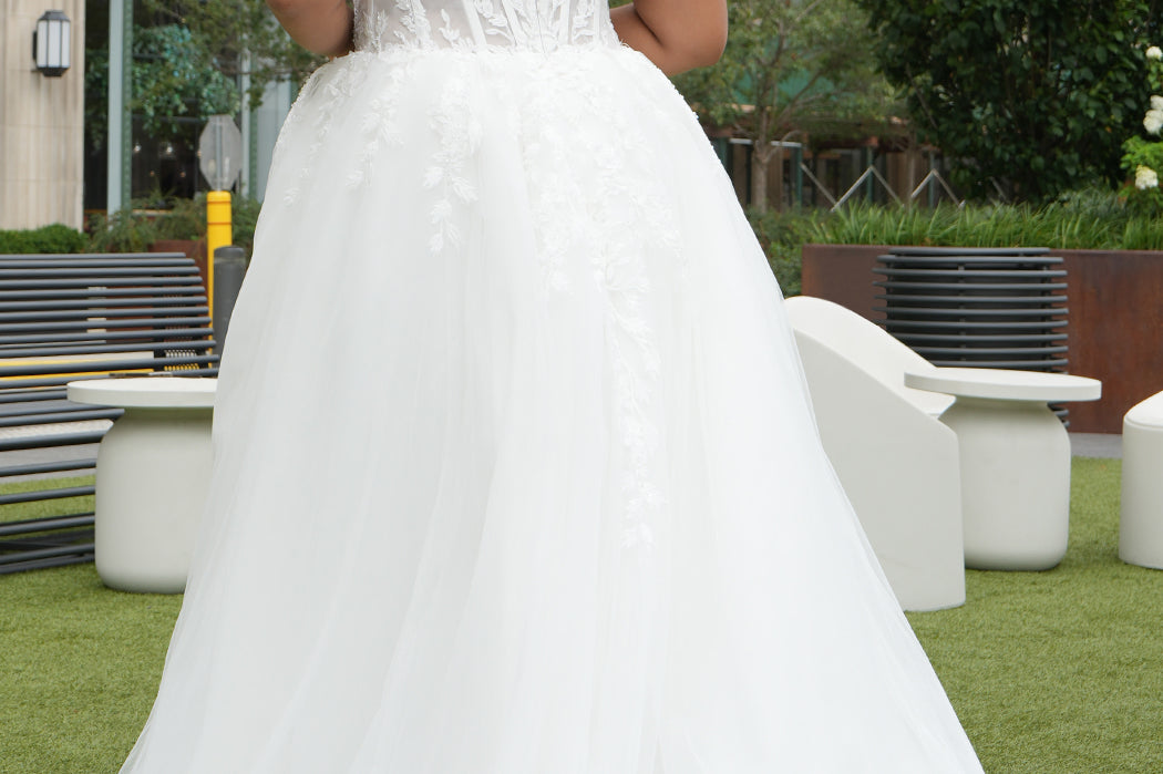 Michelle Bridal MB2620 shown in Ivory. 

Bridal ballgown with many layers of soft tulle and crinoline and satin lining. V-neckline, beaded straps, sheer bodice with floral appliques. Natural waistline and optional bodice lining. Long train and center back zipper. 