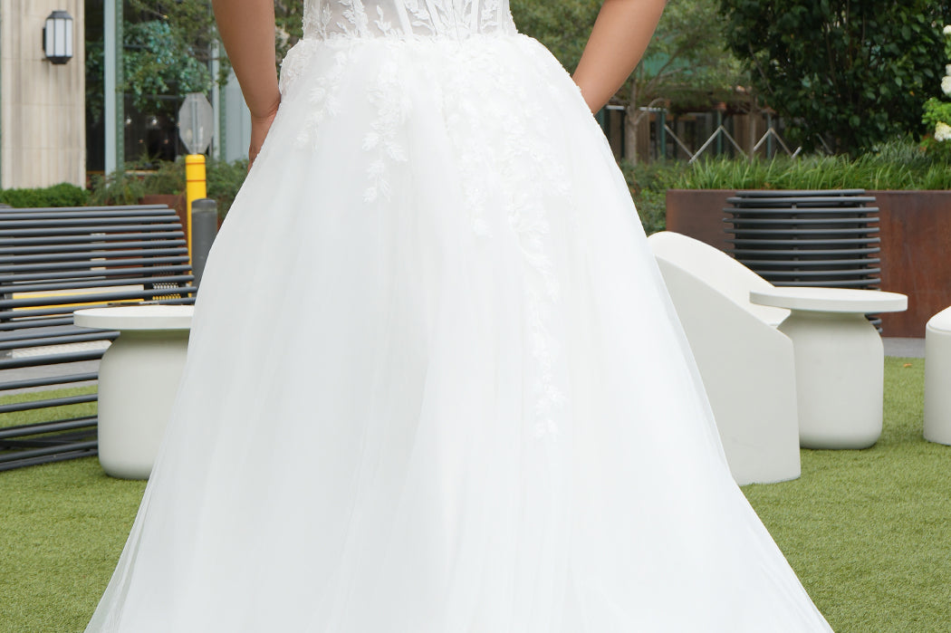 Michelle Bridal MB2620 shown in Ivory. 

Bridal ballgown with many layers of soft tulle and crinoline and satin lining. V-neckline, beaded straps, sheer bodice with floral appliques. Natural waistline and optional bodice lining. Long train and center back zipper. 