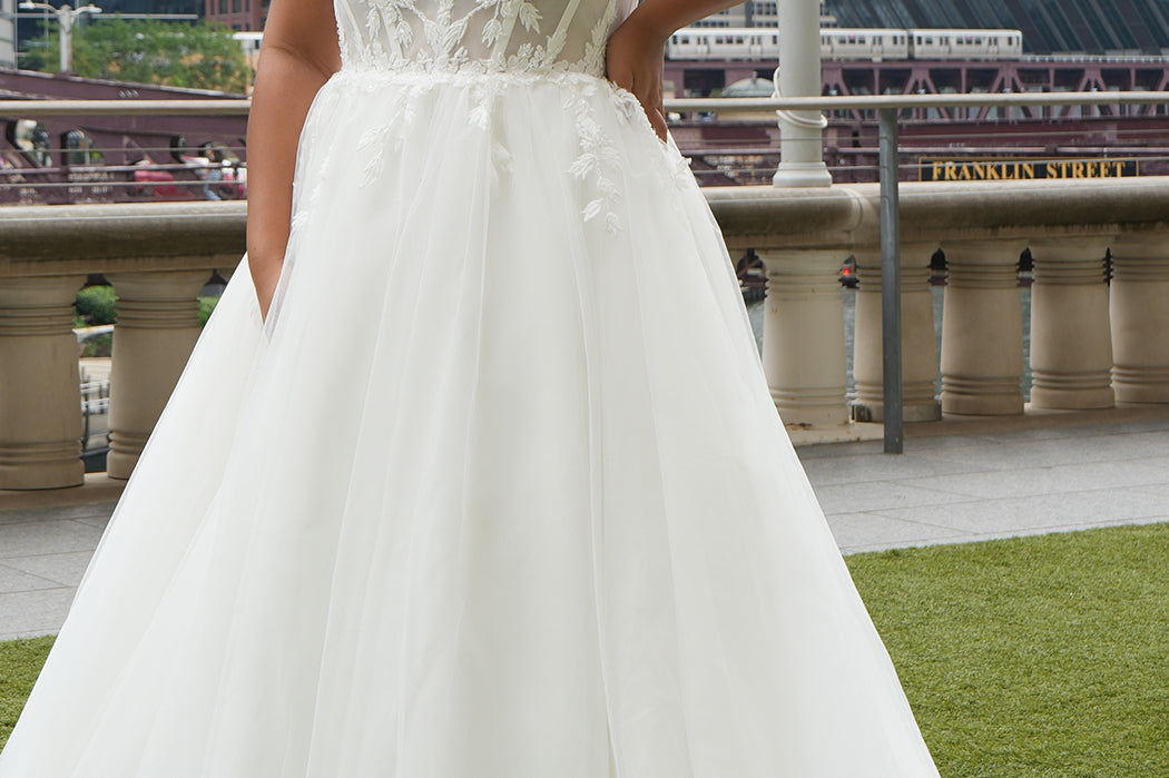 Michelle Bridal MB2620 shown in Ivory. 

Bridal ballgown with many layers of soft tulle and crinoline and satin lining. V-neckline, beaded straps, sheer bodice with floral appliques. Natural waistline and optional bodice lining. Long train and center back zipper. 