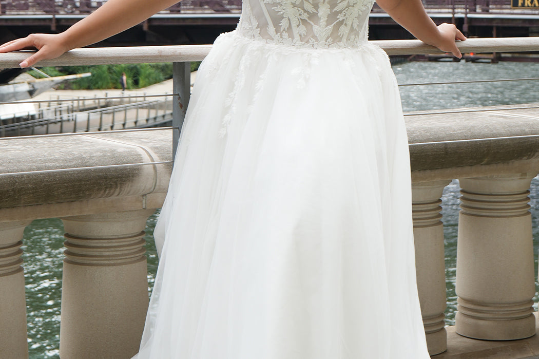 Michelle Bridal MB2620 shown in Ivory. 

Bridal ballgown with many layers of soft tulle and crinoline and satin lining. V-neckline, beaded straps, sheer bodice with floral appliques. Natural waistline and optional bodice lining. Long train and center back zipper. 