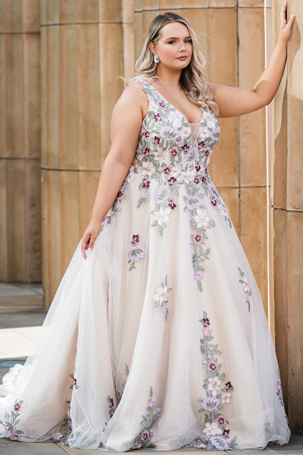 Michelle Bridal MB2622 shown in Floral Champagne. 

Ballgown with thick bra-friendly straps. V-neck, natural waistline, ballgown skirt, multi colored floral appliques, soft tulle and satin lining. Long train and center back zipper with covered buttons. 