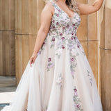 Michelle Bridal MB2622 shown in Floral Champagne. 

Ballgown with thick bra-friendly straps. V-neck, natural waistline, ballgown skirt, multi colored floral appliques, soft tulle and satin lining. Long train and center back zipper with covered buttons. 