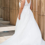 Michelle Bridal MB2622 shown in Ivory. 

Ballgown with thick bra-friendly straps. V-neck, natural waistline, ballgown skirt,  floral appliques, soft tulle and satin lining. Long train and center back zipper with covered buttons. 