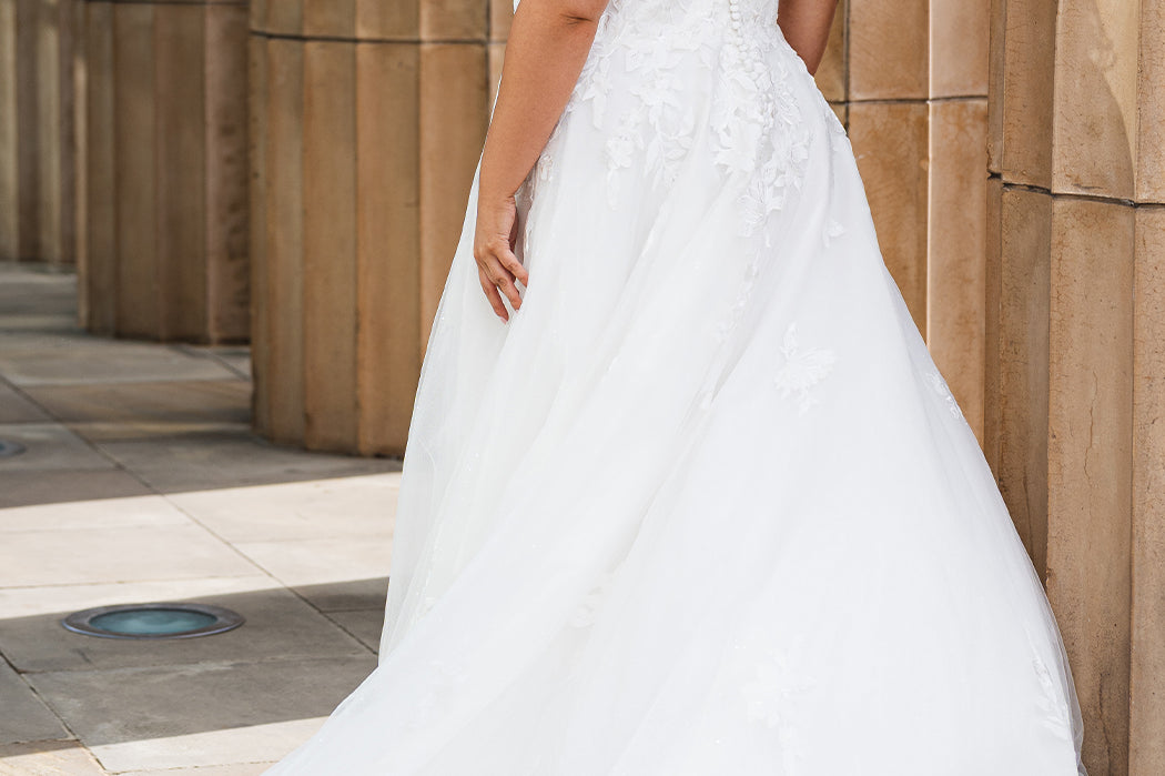 Michelle Bridal MB2622 shown in Ivory. 

Ballgown with thick bra-friendly straps. V-neck, natural waistline, ballgown skirt,  floral appliques, soft tulle and satin lining. Long train and center back zipper with covered buttons. 