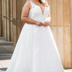 Michelle Bridal MB2622 shown in Ivory. 

Ballgown with thick bra-friendly straps. V-neck, natural waistline, ballgown skirt,  floral appliques, soft tulle and satin lining. Long train and center back zipper with covered buttons. 