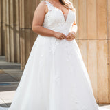 Michelle Bridal MB2622 shown in Ivory. 

Ballgown with thick bra-friendly straps. V-neck, natural waistline, ballgown skirt,  floral appliques, soft tulle and satin lining. Long train and center back zipper with covered buttons. 