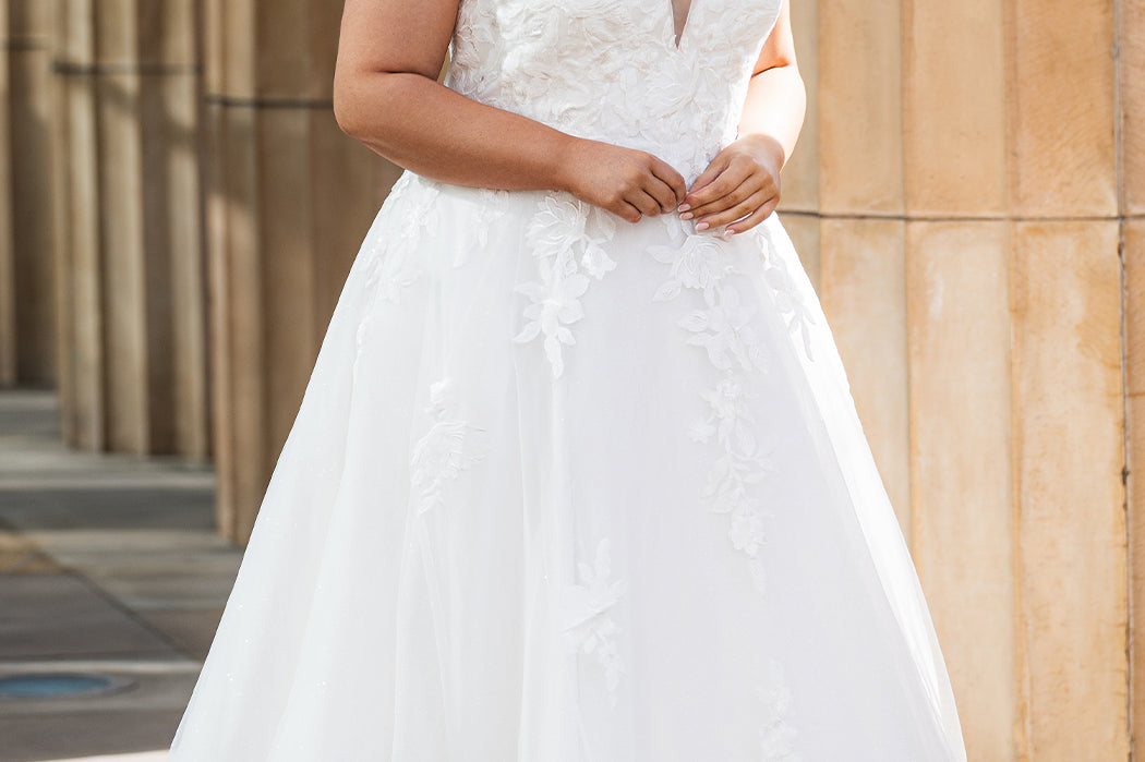 Michelle Bridal MB2622 shown in Ivory. 

Ballgown with thick bra-friendly straps. V-neck, natural waistline, ballgown skirt,  floral appliques, soft tulle and satin lining. Long train and center back zipper with covered buttons. 