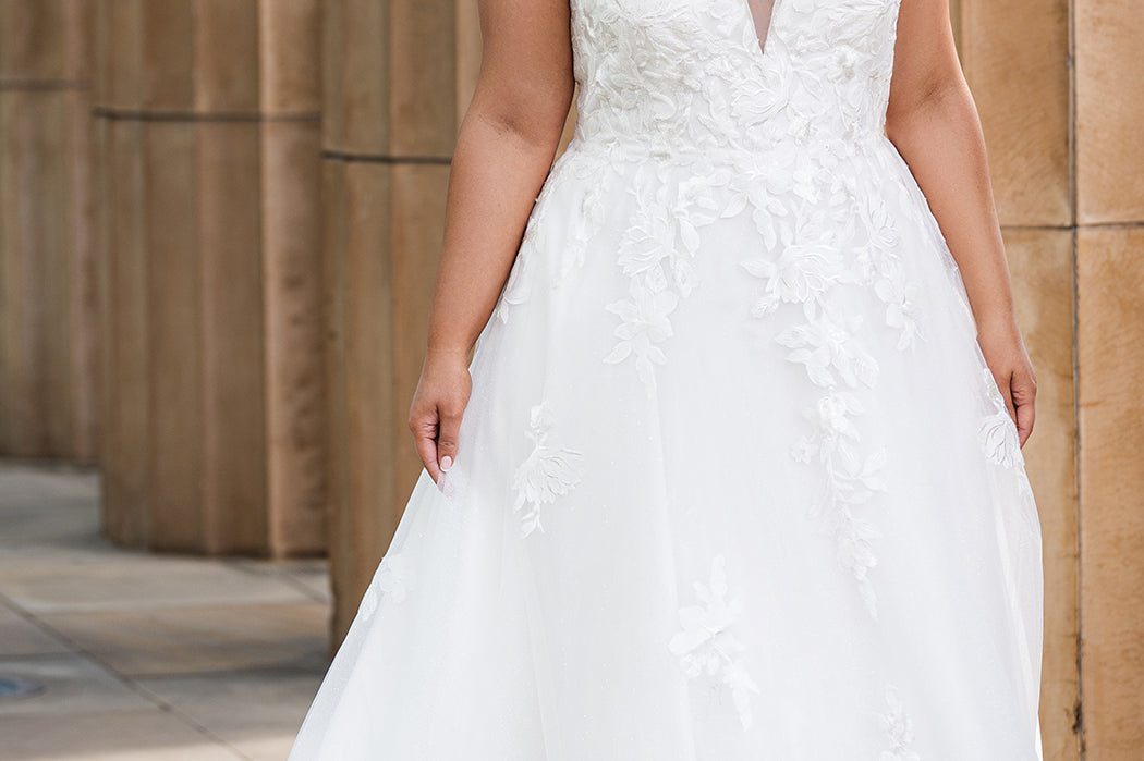 Michelle Bridal MB2622 shown in Ivory. 

Ballgown with thick bra-friendly straps. floral appliques, soft tulle and satin lining. Long train and center back zipper with covered buttons. 