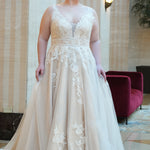 Michelle Bridal MB2624 shown in Ivory/Champagne. 

Bra-friendly straps, v-neckline, A-line skirt. Soft bridal tulle, lace appliques and satin lining. 3 inch waistband, natural waistline, v-back, long train and center back zipper. 