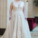 Michelle Bridal MB2624 shown in Ivory/Champagne. 

Bra-friendly straps, v-neckline, A-line skirt. Soft bridal tulle, lace appliques and satin lining. 3 inch waistband, natural waistline, v-back, long train and center back zipper. 