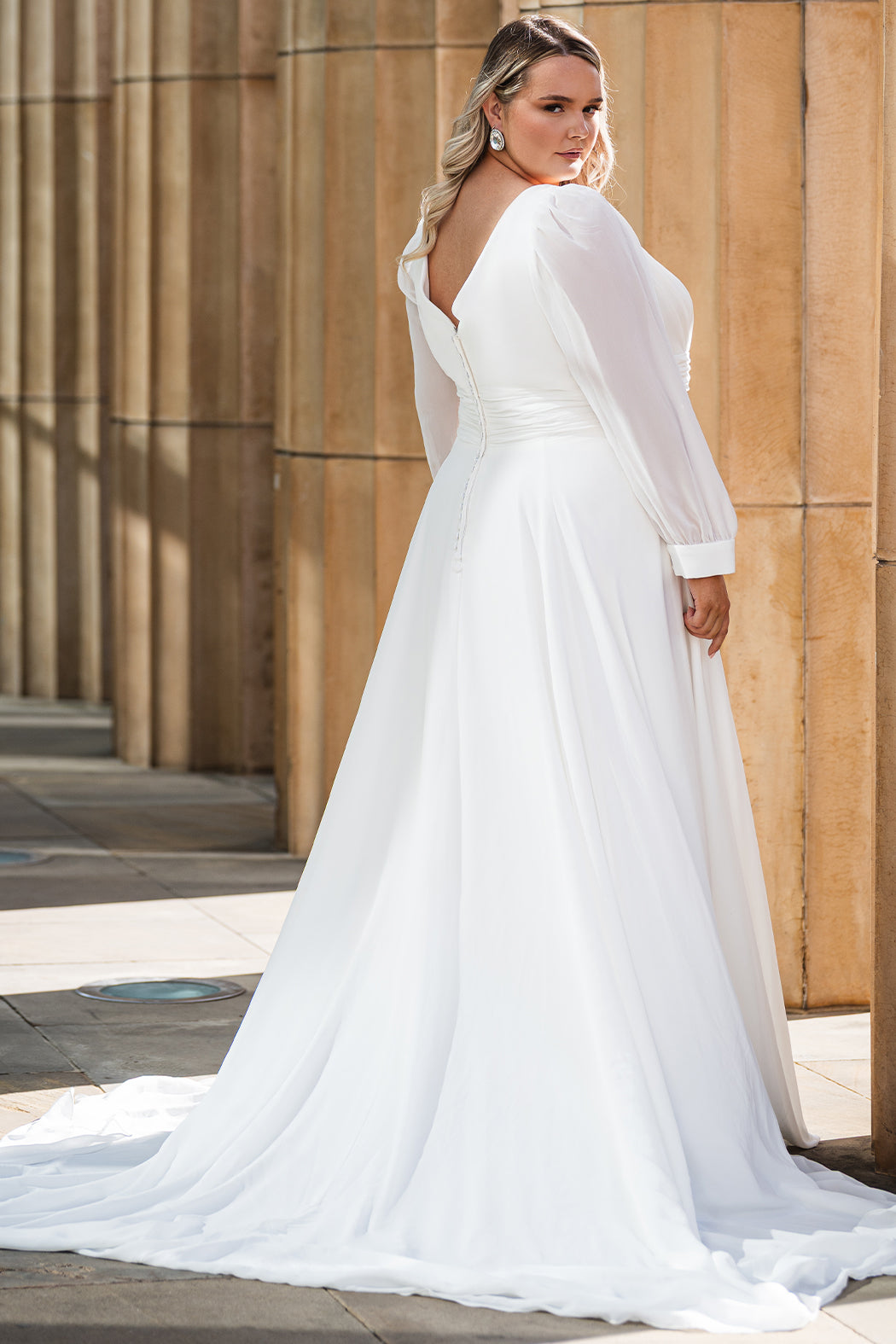 Sydney's Closet SC5320 ivory. Bridal chiffon, Satin lining, Silhouette: A-line, Neckline: V-neckline, Lightly pleated bodice, Bra-friendly straps, Long sleeves with cuff, Fully lined, Natural waistline, V-back, Long invisible center back zipper.