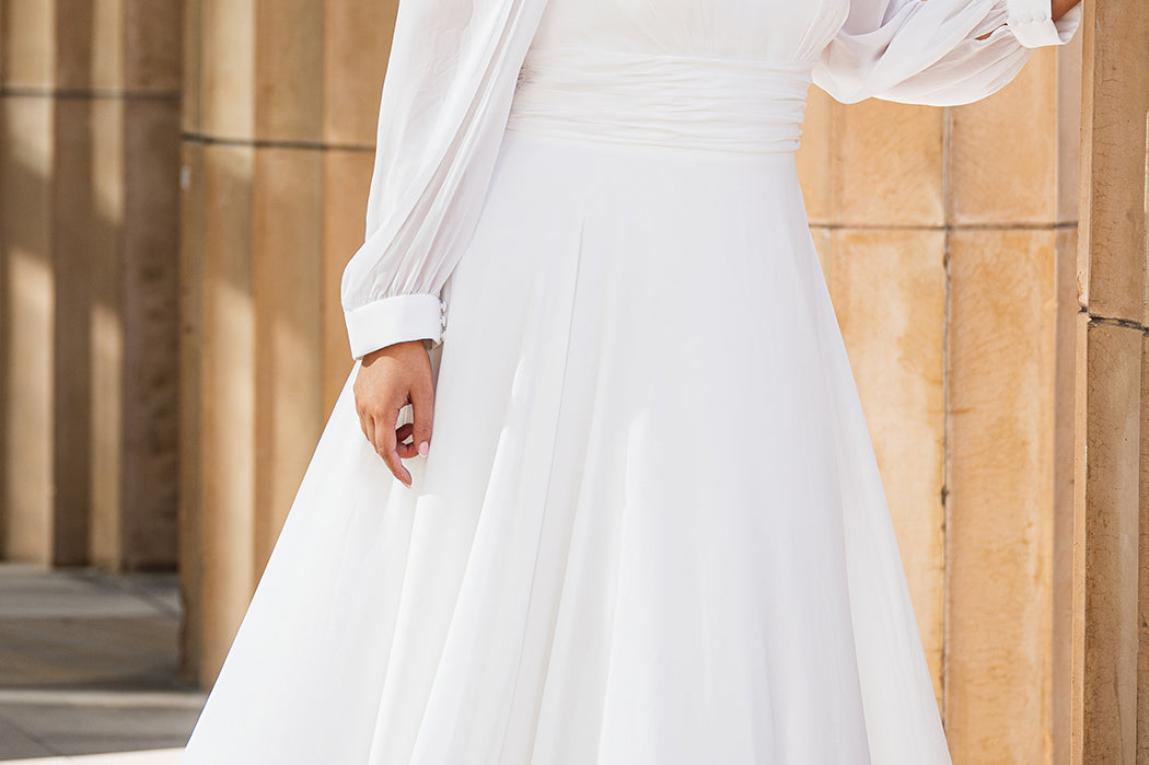 Sydney's Closet SC5320 ivory. Bridal chiffon, Satin lining, Silhouette: A-line, Neckline: V-neckline, Lightly pleated bodice, Bra-friendly straps, Long sleeves with cuff, Fully lined, Natural waistline, V-back, Long invisible center back zipper.