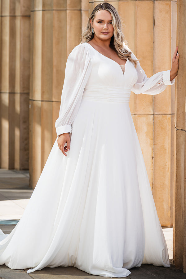 Sydney's Closet SC5320 ivory. Bridal chiffon, Satin lining, Silhouette: A-line, Neckline: V-neckline, Lightly pleated bodice, Bra-friendly straps, Long sleeves with cuff, Fully lined, Natural waistline, V-back, Long invisible center back zipper.