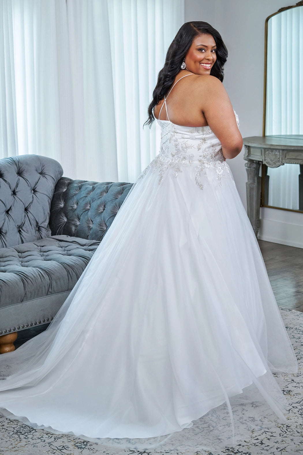 Sydney's Closet plus size wedding dress with lace up back and modesty panel.  V-neckline embelished with 3D floral appliques and silver stones.  Full A-line skirt and long train. Style SC5345