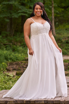 Sydney's Closet plus size wedding dress with sweetheart neckline,spaghetti straps and flowing chiffon skirt with slit. Lace covered bodice comes unlined with optional lining included. Style SC5348 is avialable in ivory