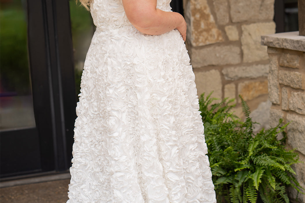 Plus size formal event dress or unique edgy wedding dress. 3D floral fabric. Scoop neckline with cat-eye detail, detachable drape sleeves, A-line skirt with pockets and train.  Sydney's Closet style SC7397 for formal gown or SC5354 for bridal gown is available in black or ivory. 