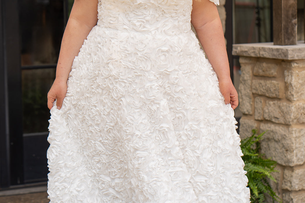 Plus size formal event dress or unique edgy wedding dress. 3D floral fabric. Scoop neckline with cat-eye detail, detachable drape sleeves, A-line skirt with pockets and train.  Sydney's Closet style SC7397 for formal gown or SC5354 for bridal gown is available in black or ivory. 