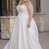 Plus size floral brocade wedding dress style SC5263 from designer Sydney's Closet.  Strapless, straight across neckline with folded cuff detail. Full A-line skirt with box pleats, crinoline and pockets. Long train and center back zipper. 