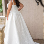 Plus size brocade wedding gown with square neckline and wide straps.  Exposed corset boning and basque waistline make for an elogating fit.  Gathered A-line skirt with pockets and a train add a traditional touch.  Sydney's Closet SC5363 is available in Buttercream. 