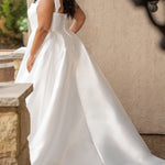 Sydney's Closet style SC5365 - Ivory bridal Mikado satin wedding dress with square neckline, wide straps with detachable bows, natural waistline, full A-line skirt with box pleats, pockets and a long train. 
