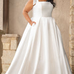 Sydney's Closet style SC5365 - Ivory bridal Mikado satin wedding dress with square neckline, wide straps with detachable bows, natural waistline, full A-line skirt with box pleats, pockets and a long train. 
