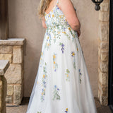 Sydney's Closet SC5371 plus size wedding dress.  Multi-colored floral lace on ivory tulle. Sexy plunging V-neckline with exposed corset boning.  Basque waistline on A-line skirt with slit and long train with lace details. Perfect for the unique, trendy bride.