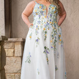Sydney's Closet SC5371 plus size wedding dress.  Multi-colored floral lace on ivory tulle. Sexy plunging V-neckline with exposed corset boning.  Basque waistline on A-line skirt with slit and long train with lace details. Perfect for the unique, trendy bride.