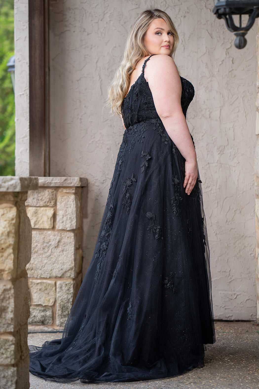 Sydney's Closet SC5372 plus size wedding dress.  Black floral lace on black tulle. Sexy plunging V-neckline with exposed corset boning.  Basque waistline on A-line skirt with slit and long train with lace details. Perfect for the unique, alternative bride. 