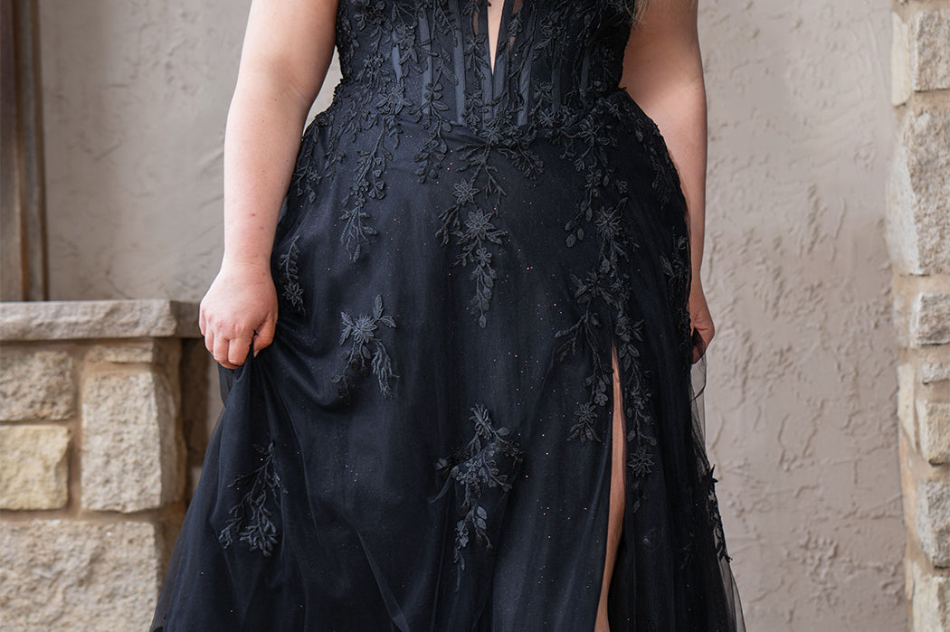 Sydney's Closet SC5372 plus size wedding dress.  Black floral lace on black tulle. Sexy plunging V-neckline with exposed corset boning.  Basque waistline on A-line skirt with slit and long train with lace details. Perfect for the unique, alternative bride. 