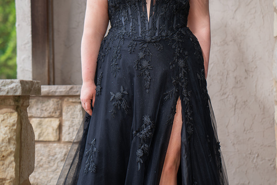 Sydney's Closet SC5372 plus size wedding dress.  Black floral lace on black tulle. Sexy plunging V-neckline with exposed corset boning.  Basque waistline on A-line skirt with slit and long train with lace details. Perfect for the unique, alternative bride. 