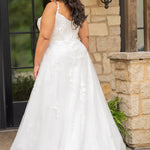 Sydney's Closet SC5372 plus size wedding dress.  Ivory floral lace on ivory tulle. Sexy plunging V-neckline with exposed corset boning.  Basque waistline on A-line skirt with slit and long train with lace details. 