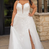 Sydney's Closet SC5372 plus size wedding dress.  Ivory floral lace on ivory tulle. Sexy plunging V-neckline with exposed corset boning.  Basque waistline on A-line skirt with slit and long train with lace details. 