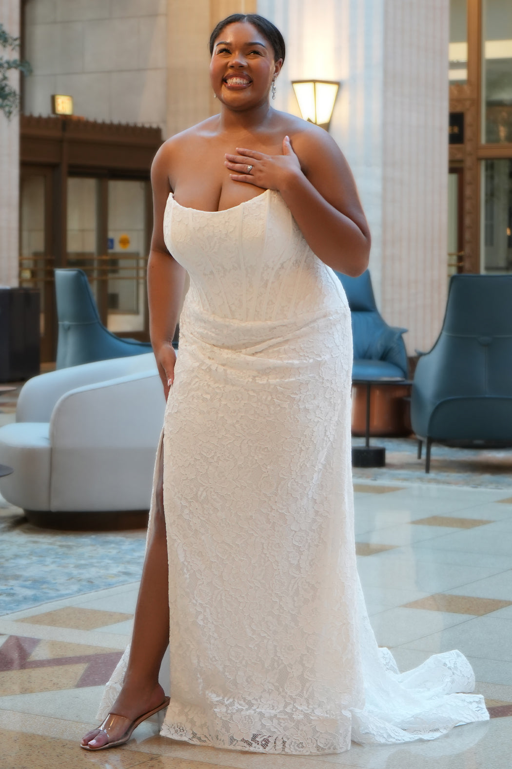 Sydney's Closet style SC5374 in ivory.

Strapless stretch lace, cat eye bodice, exposed boning,  asymmetrical waist, zipper back, ruched lace skirt and horse hair hem. 
