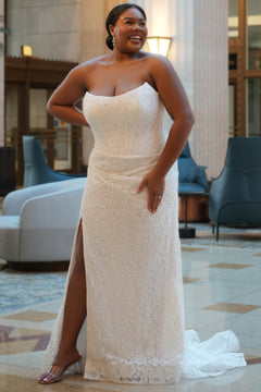 Sydney's Closet style SC5374 in ivory.

Strapless stretch lace, cat eye bodice, exposed boning,  asymmetrical waist, zipper back, ruched lace skirt and horse hair hem. 