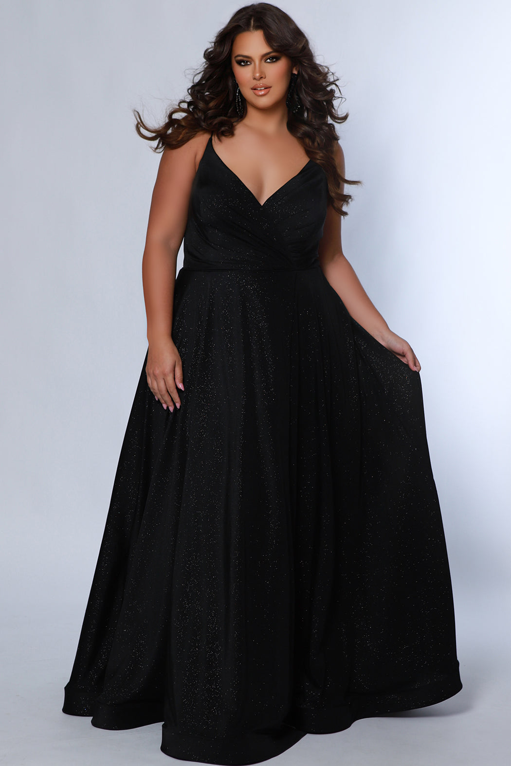Sydney's Closet SC7375 Black. Aline silhouette, Stretch jersey with sparkle over stretch knit lining, V-neckline, Spaghetti straps, Natural waistline, Aline skirt with pockets.