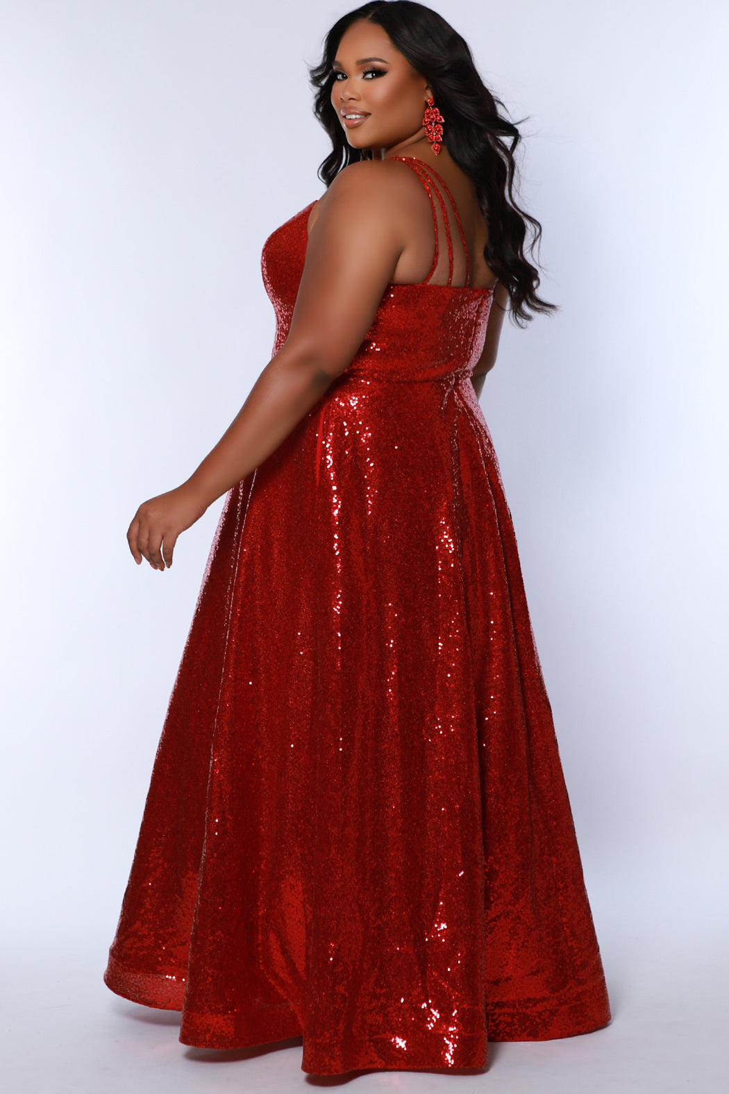 Sydney's Closet SC7387 Red. All over dense sequin, scoop neckline, sequin covered straps, floor length A-line skirt, horse hair hem, center back zipper.