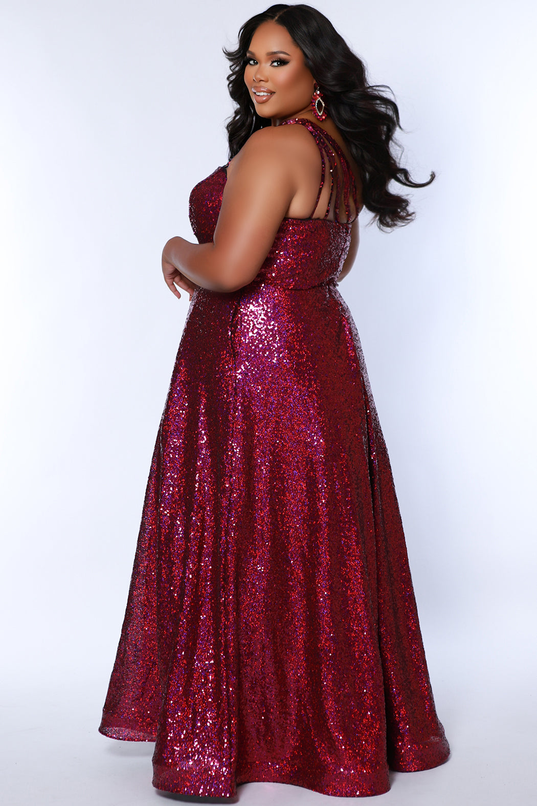 Sydney's Closet SC7389 Magenta. Dense sequin, A-line skirt, sweetheart neckline with sequin covered straps that cross the front of the chest, natural waistline, center back zipper, floor length.
