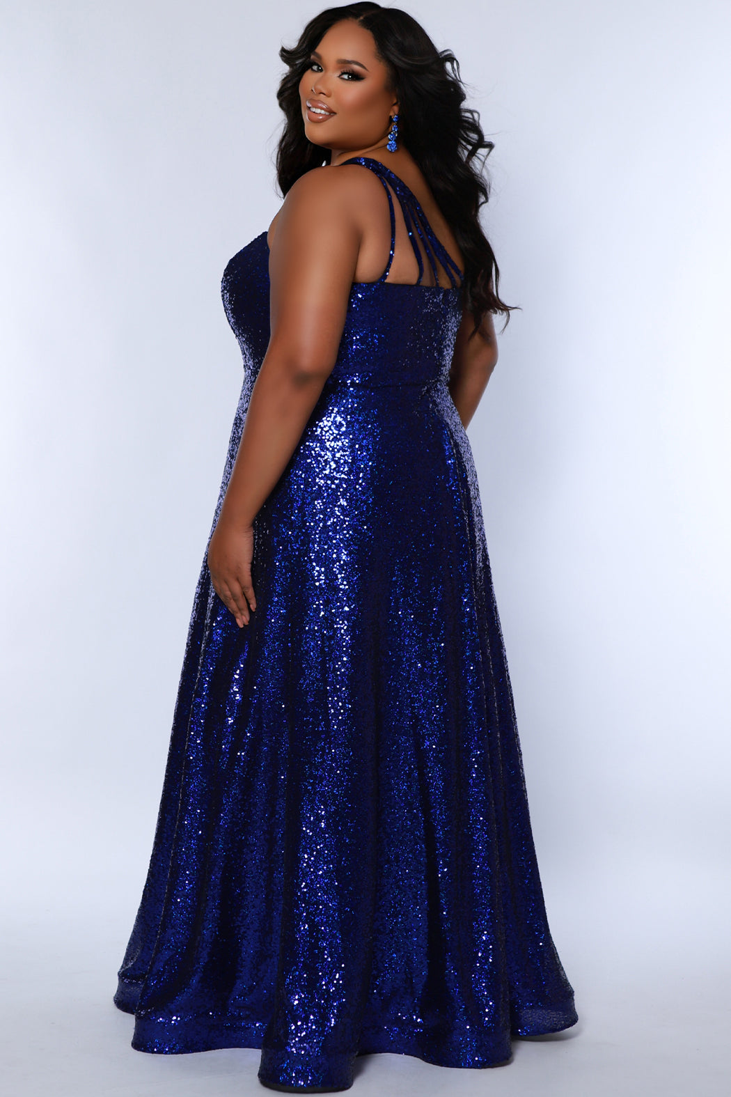 Sydney's Closet SC7389 Sapphire. Dense sequin,  A-line skirt, sweetheart neckline with sequin covered straps that cross the front of the chest, natural waistline, center back zipper, floor length.