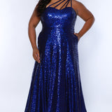 Sydney's Closet SC7389 Sapphire. Dense sequin, A-line skirt, sweetheart neckline with sequin covered straps that cross the front of the chest, natural waistline, center back zipper, floor length.