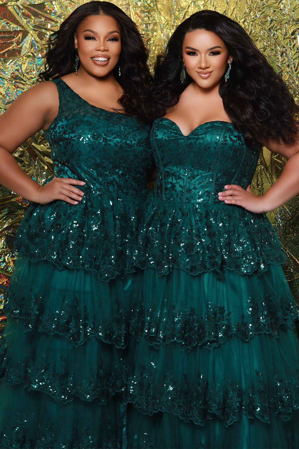 SC7398 & SC7399 duo picture with oversized candy for prom 2025. 

Strapless, sweetheart plus size gala formal ballgown. Exposed corset boning on bodice covered in lace applqiues. Tiered A-line skirt with matching lace applique hem. Style SC7398 is available in forest green, navy blue or burgundy red by Sydney's Closet. 

Plus size one-shoulder formal gala Mardi Gras gown with embroidered sequin lace appliques on bodice and on tiered A-line skirt with slit. Available in forest green. navy blue and burgundy r