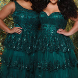 SC7398 & SC7399 duo picture with oversized candy for prom 2025. 

Strapless, sweetheart plus size gala formal ballgown. Exposed corset boning on bodice covered in lace applqiues. Tiered A-line skirt with matching lace applique hem. Style SC7398 is available in forest green, navy blue or burgundy red by Sydney's Closet. 

Plus size one-shoulder formal gala Mardi Gras gown with embroidered sequin lace appliques on bodice and on tiered A-line skirt with slit. Available in forest green. navy blue and burgundy r