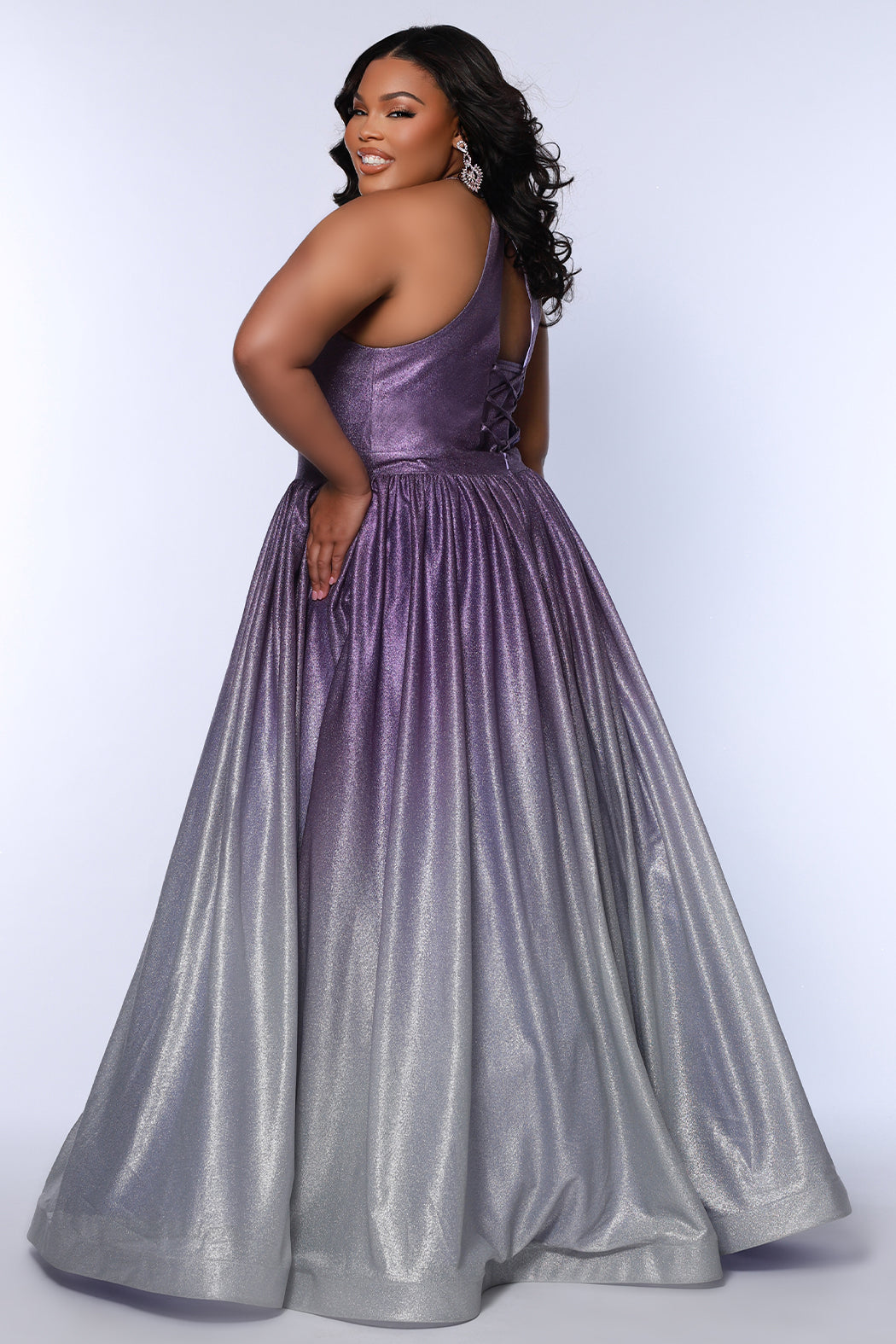 Plus size ombre prom ballgown. Halter neckline with nude mesh insert, waistband, gathered A-line skirt with pockets and horsehair hem.  Lace-up back with modesty panel. Available in purple or green by Sydney's Closet.