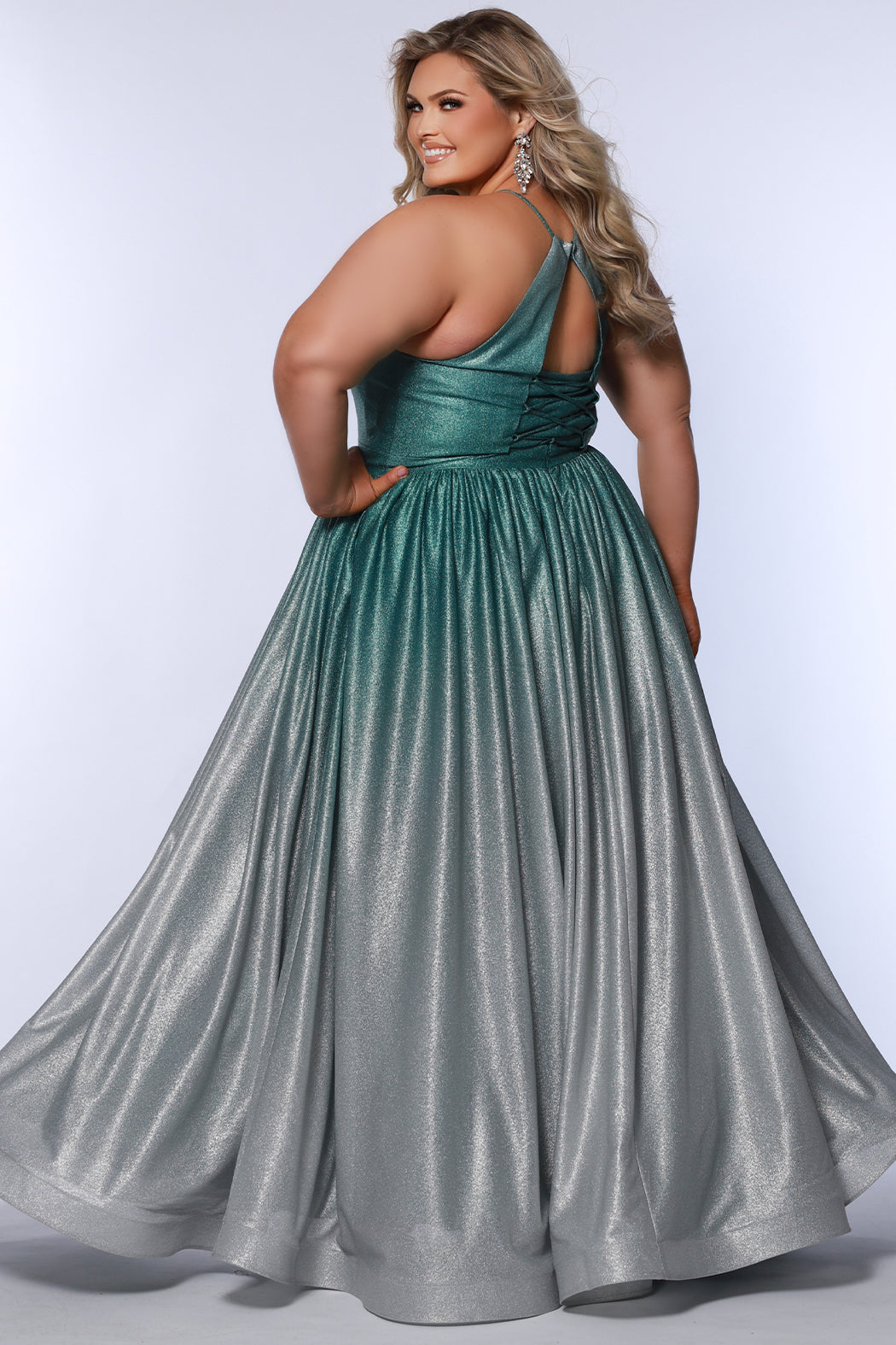 Plus size ombre prom ballgown. Halter neckline with nude mesh insert, waistband, gathered A-line skirt with pockets and horsehair hem.  Lace-up back with modesty panel. Available in purple or green by Sydney's Closet.