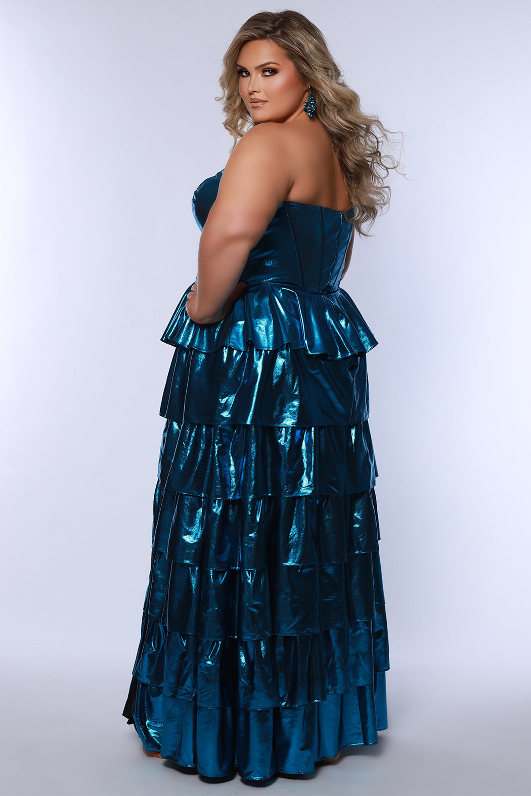 SC7405 by Sydney's Closet. Plus size strapless sweetheart metallic knit gown with exposed boning on bodice.  Tiered A-line skirt slit. Available in magenta pink, copper gold/brown and turq blue green.