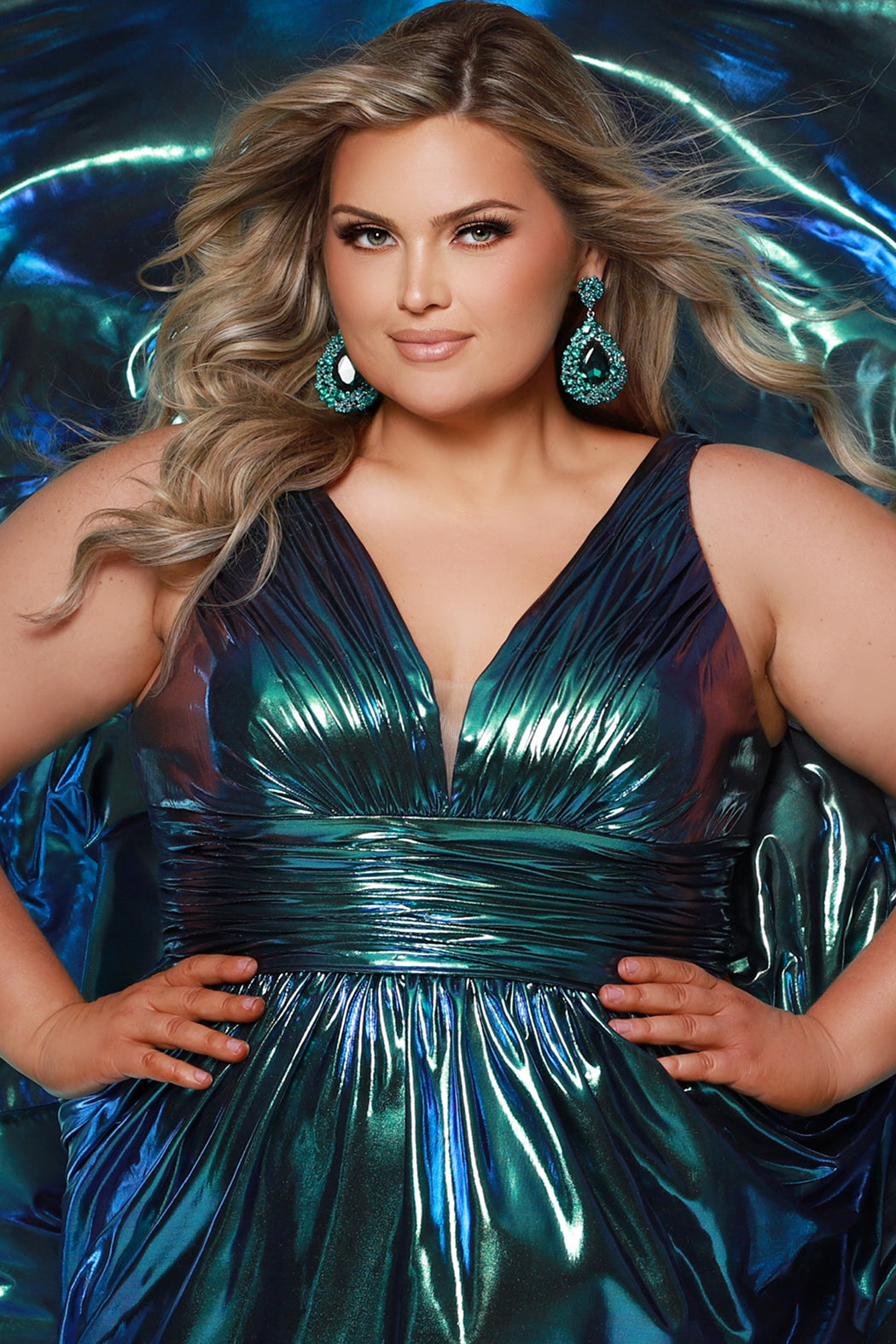 Best selling plus size A-line prom, formal and evening dress. Metallic stretch knit novelty fabric, bra-friendly straps, full A-line skirt and pockets. Available in peacock (blue/green) and Prism (blue/purple) sizes 14-40. SC7415 by Sydney's Closet